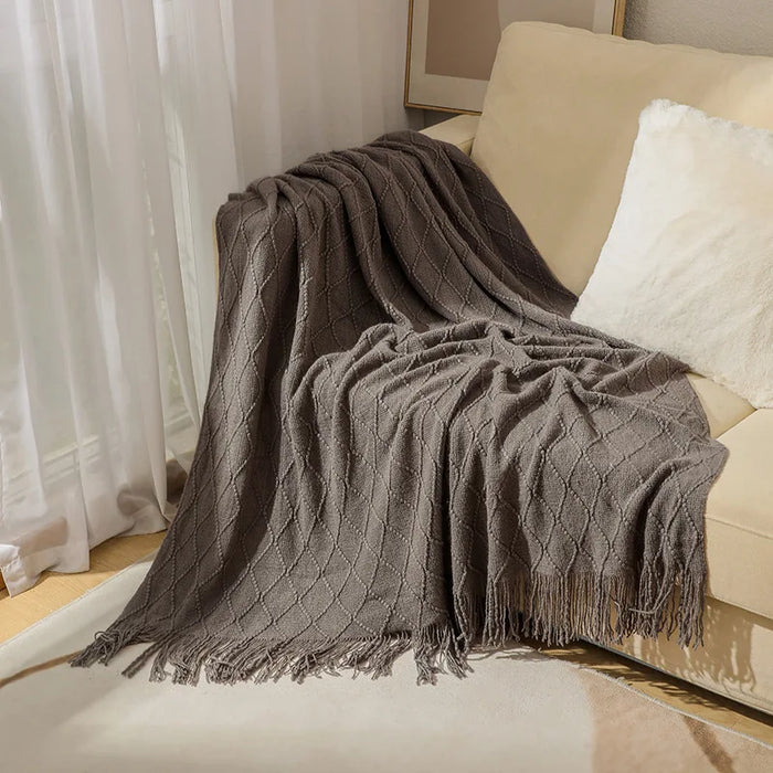 Smoky grey diamond knit throw on a sofa