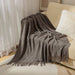 Smoky grey diamond knit throw on a sofa