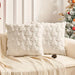 Two white plush Christmas tree cushions on a sofa