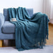Blue diamond knit throw on a blue sofa