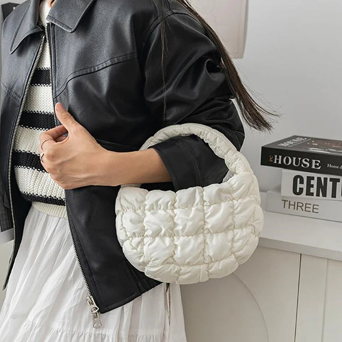 Woman carrying a white mini puffer tote