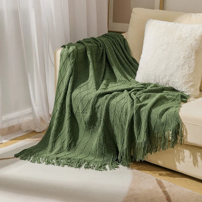 Green diamond knit throw blanket on a sofa