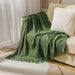 Green diamond knit throw blanket on a sofa
