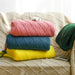 Folded diamond knit throws in pink, teal, yellow and green