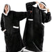 Two people in black long blanket hoodies