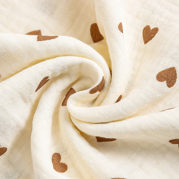 Close-up of crinkled cotton muslin with brown hearts