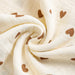 Close-up of crinkled cotton muslin with brown hearts