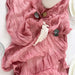 Dusty pink gauze table runner with a feather