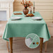 Sage green linen-look tablecloth on a dining table