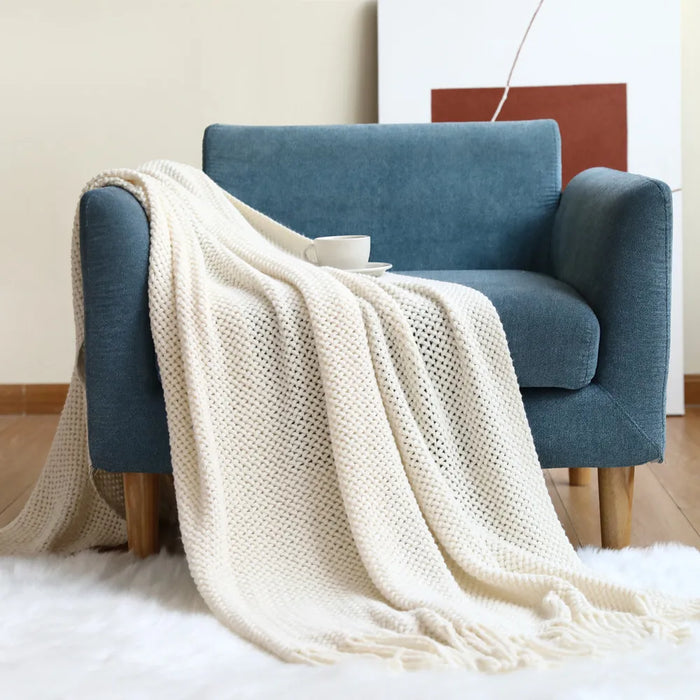 Cream net knit throw on a blue armchair
