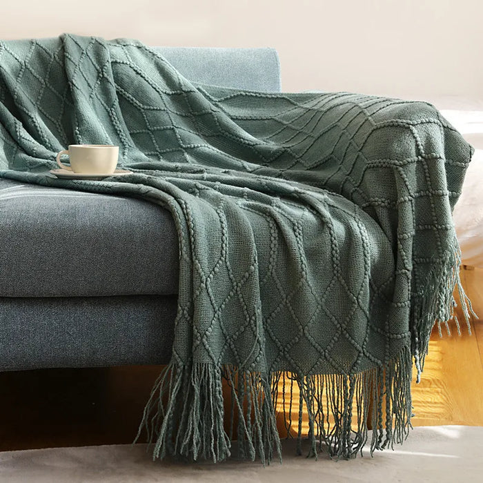 Lake green cable knit throw on a sofa