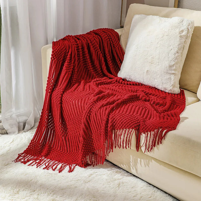 Red bubble knit throw on a cream sofa