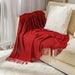Red bubble knit throw on a cream sofa