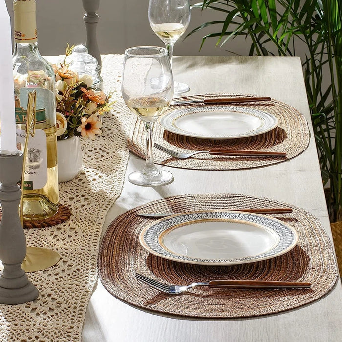 Oval braided placemats with plates and glasses on a dining table