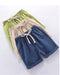 Green, beige and dark blue kids' shorts stacked