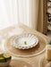 White plate on a round woven placemat by a window