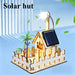 Solar hut with a white picket fence and a small fan
