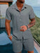 Man in a grey short sleeve shirt and shorts set
