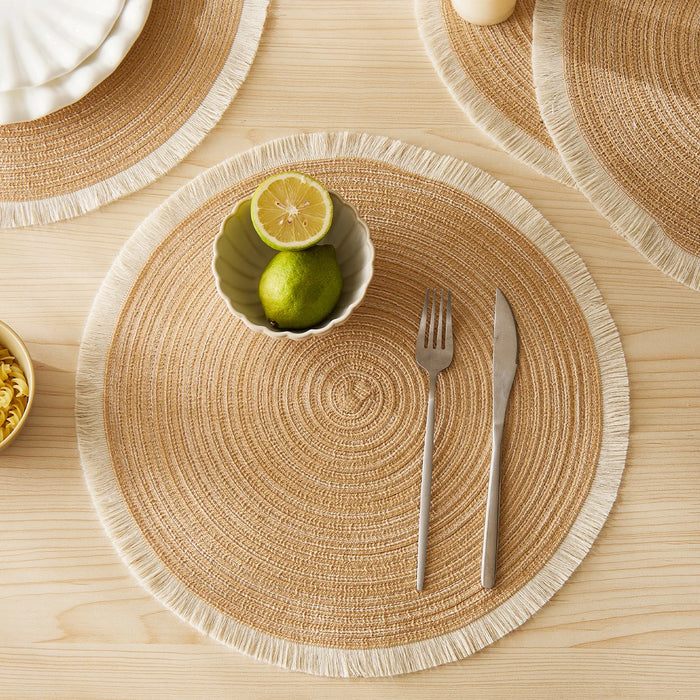 Natural woven round placemat with a lime bowl and cutlery