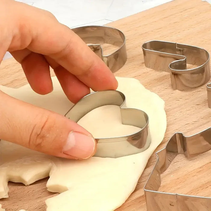 Hand pressing a heart cookie cutter into rolled dough