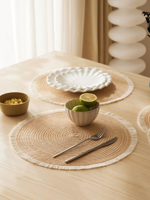 Round placemats with plates and a bowl of limes