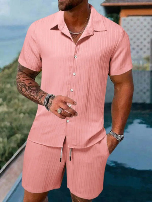 Man in a pink short sleeve shirt and shorts set