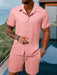 Man in a pink short sleeve shirt and shorts set