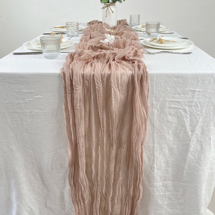 Beige gauze runner on a white dinner table