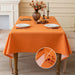 Orange linen-look tablecloth on a dining table