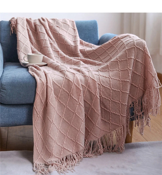 Pink diamond knit throw on a sofa
