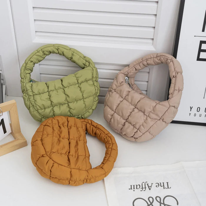 Olive, beige and caramel mini puffer totes on a table