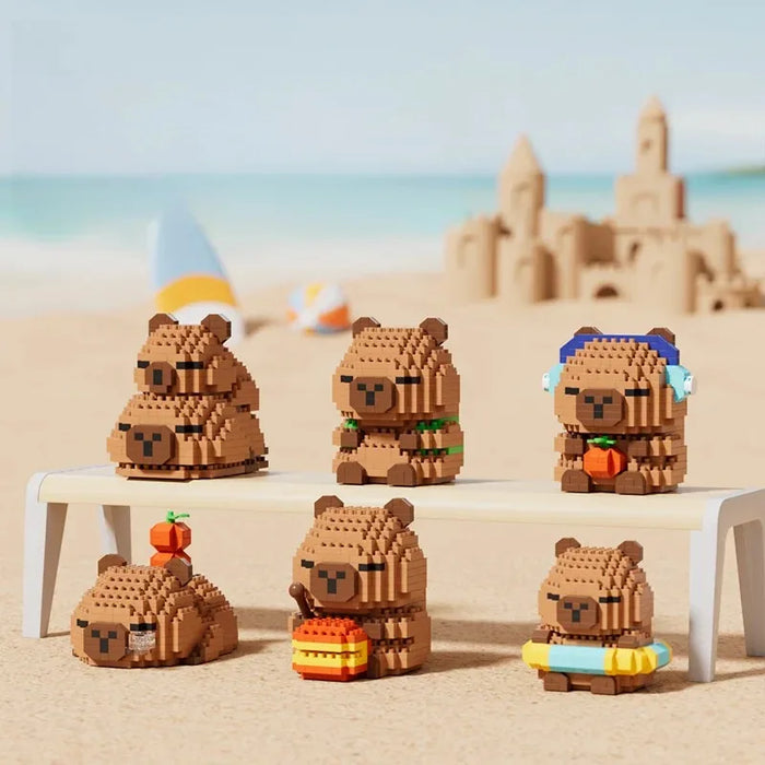 Six capybara micro block figures on a beach-themed display