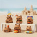Six capybara micro block figures on a beach-themed display