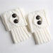Pair of white knit leg warmers with two buttons