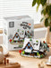 Snowy cabin set in front of its box