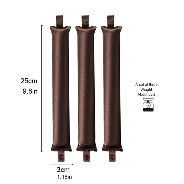 Three brown curling rods, about 25 cm long and 3 cm wide
