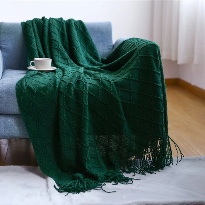 Dark green diamond knit throw on a sofa