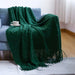 Dark green diamond knit throw on a sofa