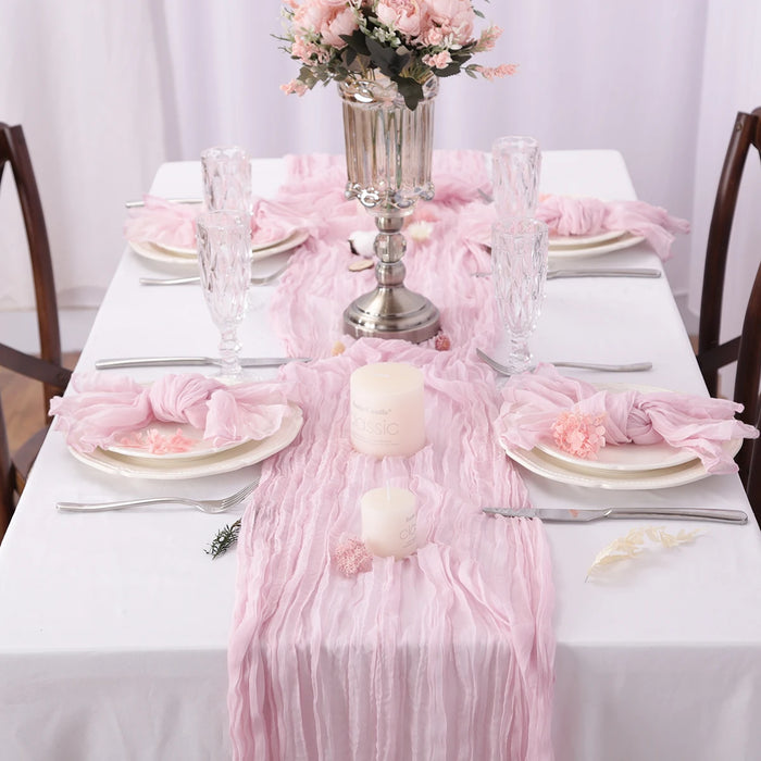 Pink purple gauze runner on a set dinner table