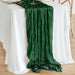 Dark green gauze runner on a white round table