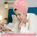 Woman reading with her hair wrapped in a pink hair towel
