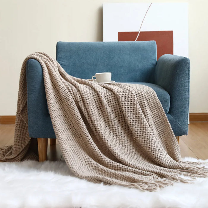 Khaki net knit throw on a blue armchair