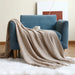 Khaki net knit throw on a blue armchair