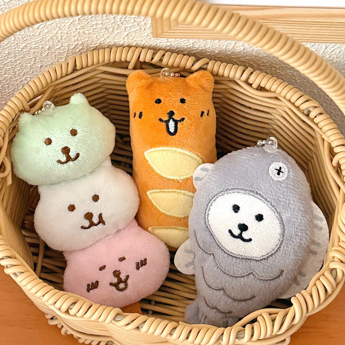 Three food plush charms in a wicker basket