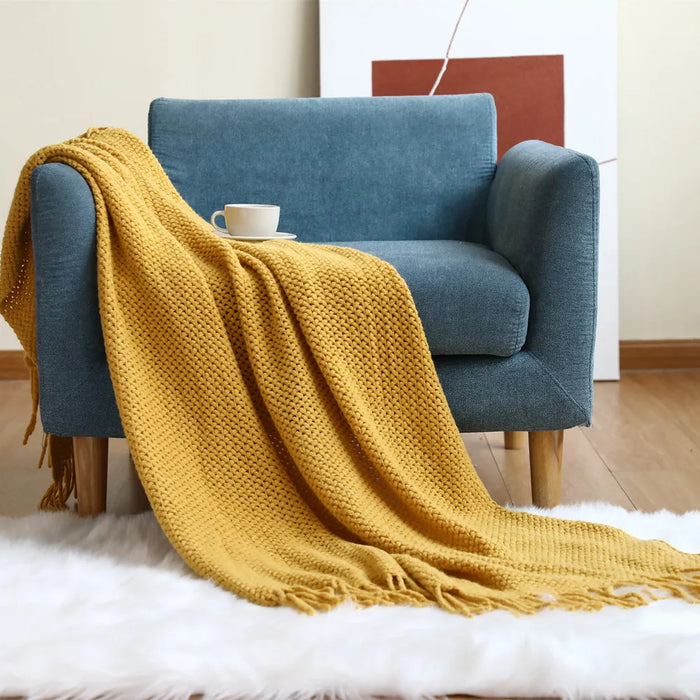 Yellow net knit throw on a blue armchair