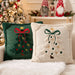 Green and beige Christmas tree cushion pair on a sofa