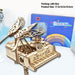 Piano music box beside its retail box, 17.5 x 16.5 x 18.5 cm