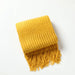 Folded yellow bubble knit throw