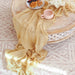 Mustard yellow gauze runner on a round table