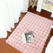 Pink faux fur bubble rug by a bed with a magazine